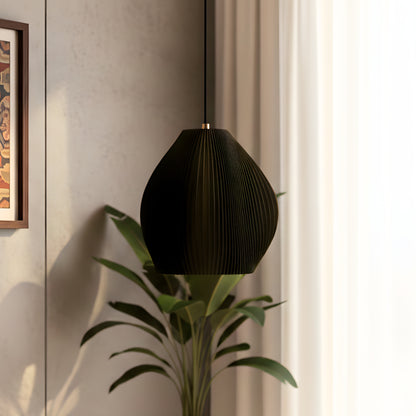 Matte black table lamp with a curved sculpted form and soft glow