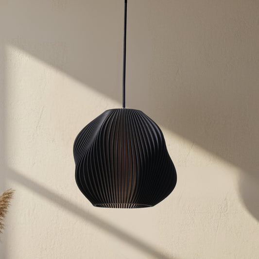 Matte black table lamp with a structured form and soft glow