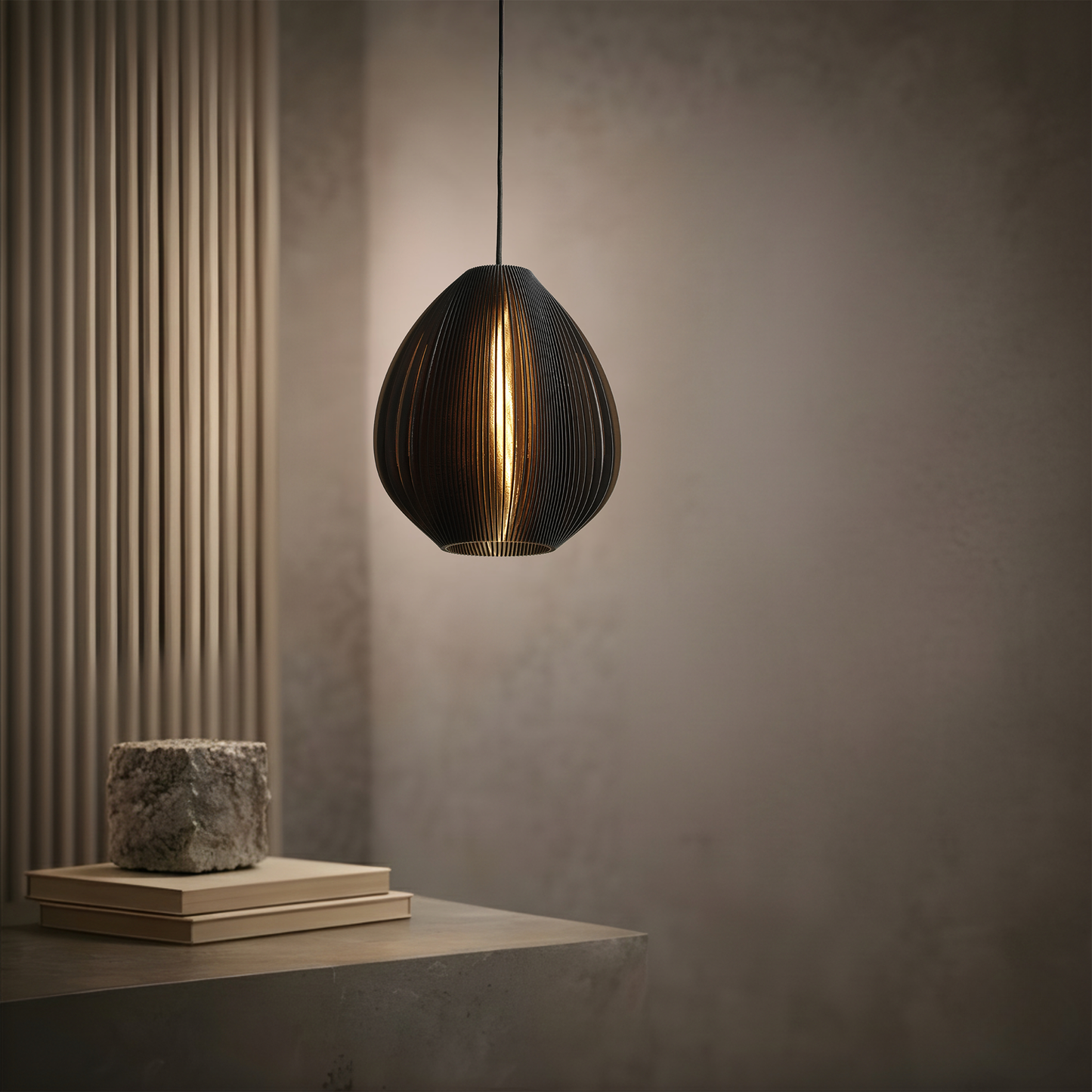 Matte black table lamp with a smooth flowing shape and soft glow