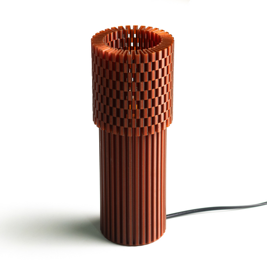 Neutral table lamp with a solid form and soft warm glow