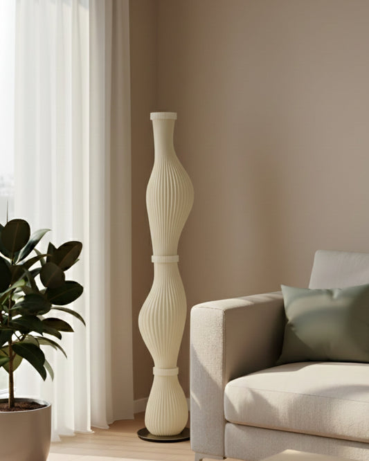 Tall sculpted floor lamp with ribbed curves and a soft warm glow