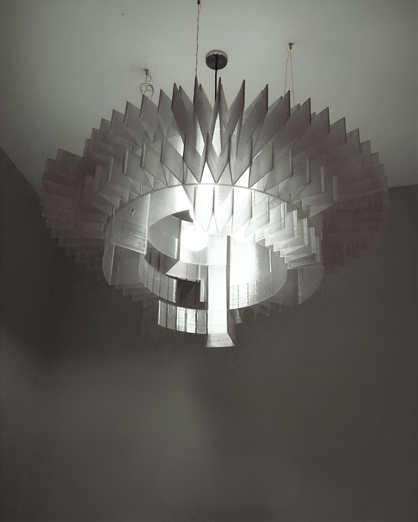 Floral inspired chandelier with layered petal-like design and warm lighting