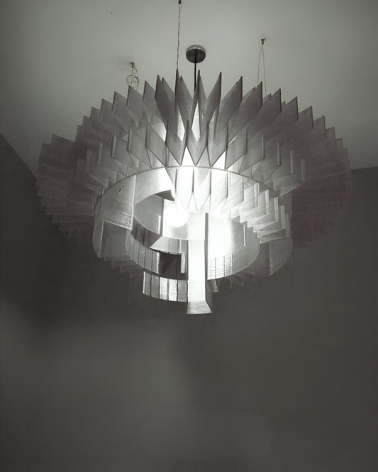 Floral inspired chandelier with layered petal-like design and warm lighting