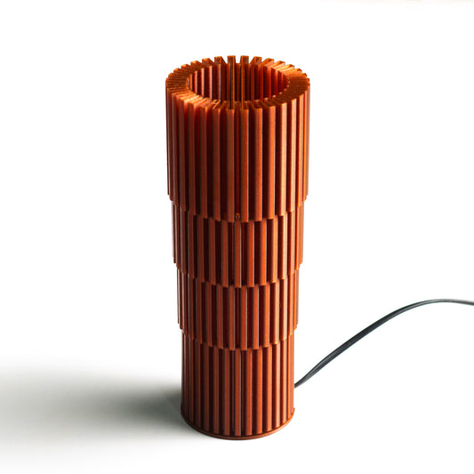 Neutral table lamp with a textured surface and soft warm glow
