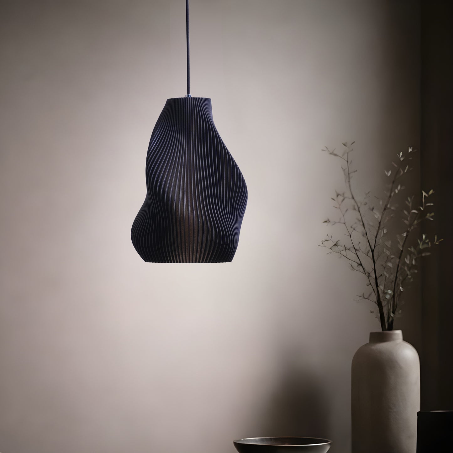 Matte black table lamp with a clean silhouette and soft glow